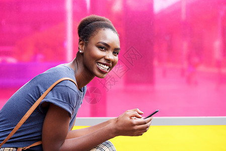 手持手机的非洲女性笑着微笑的美国女性快乐黑色电话女士女孩喜悦技术闲暇背景图片
