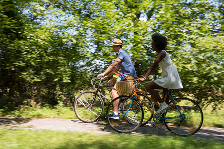 农村男人具有自然骑自行车的多种族年轻夫妇森林女性活动运动骑术乐趣天空男生男性城市背景