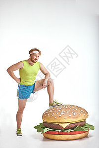 红头发 胡胡子 大胖子 把他的腿放在一个巨大的三明治上健身房肥胖男人腹部胡子损失身体成人重量运动背景图片