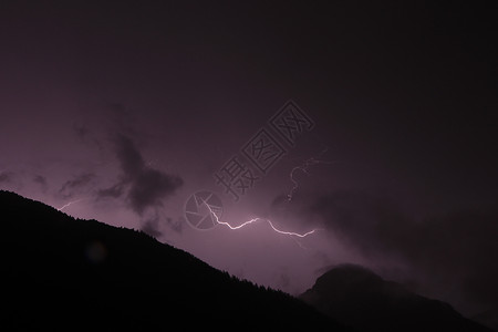 闪电风暴山黑紫两色背景的山上闪电 闪电 闪电和闪电雷雨危险损害极端气象戏剧性天空紫色收费霹雳背景