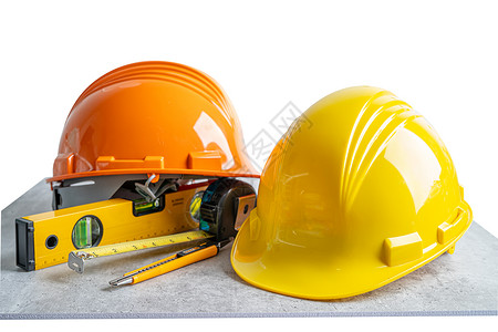 关于白色背景 工程建设和建筑概念的首套安全硬头盔帽子和工程师工具 3月1日商业塑料制造业蓝图项目财产安全帽建筑师建设者检查背景图片