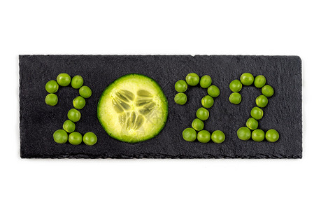 Vegan问候2022年 与 黑丝巾 上的Vegetables一同写作背景图片