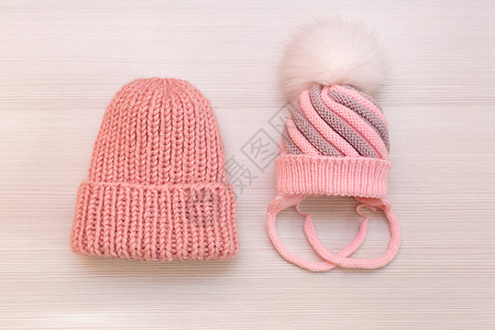 白色背景的两顶粉红色编织帽背景