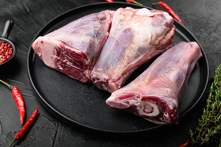 Raw 羔羊腿肉 黑色黑黑石桌背景啤酒山羊迷迭香大麦烹饪石头木板食物草本植物红色背景图片