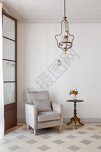 室内客厅 白色墙附近有舒适的手椅和侧桌 用老式吊灯进行回转风格背景图片