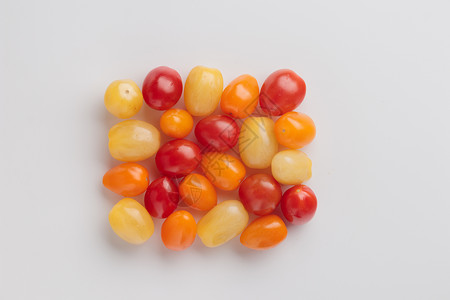 黄 橙和红樱桃西红柿饮食黄色橙子蔬菜小吃食物红色白色背景图片