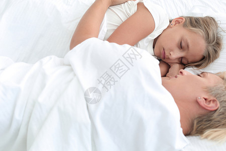 妈妈和女儿睡在一起了 一起睡着呢卧室女性幸福枕头亚麻女孩唤醒房间羽绒孩子背景图片