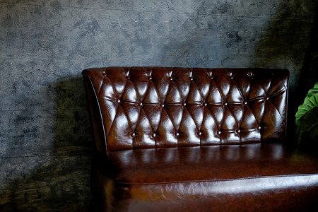 客厅的棕色皮沙发椅风格长椅装饰织物房间家具椅子皮革沙发背景图片