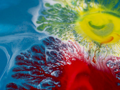 蓝色背景的红黄涂料斑点产生的红色和黄色漆线的独特发芽质感液体艺术照片线程背景图片
