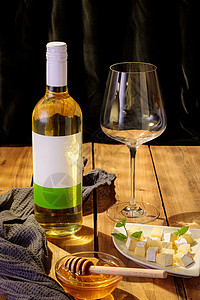 一瓶白葡萄酒 空杯子 切片奶酪和蜂蜜高清图片