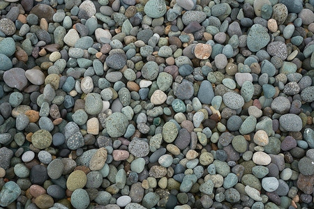 沙滩上的小石子岩背景纹理背景图片