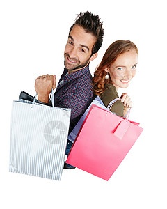 我们最喜欢做的就是买东西 一对夫妇 带着白种背景的购物袋背景图片