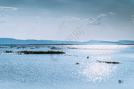 山湖 完美无缺的蓝色海洋美丽风景 水中闪亮光照耀着浮光线背景