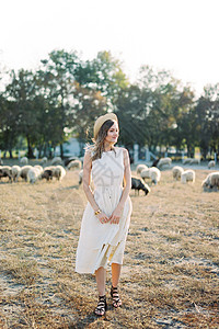 穿着草帽的女孩站在草坪上 与牧羊站在一起高清图片