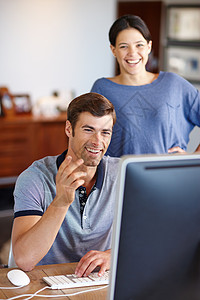 寻找最有趣的网上视频 一个年轻夫妇使用计算机在家里的一对背景图片