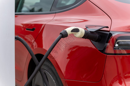 车辆加油电力供应连接到电动车 充电至电池能源发动机汽车运输引擎生态收费充值力量活力背景