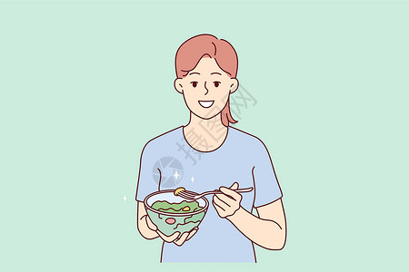 端着碗女孩微笑的妇女吃健康的蔬菜沙拉;设计图片