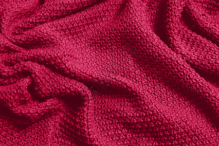 色调单色纹理针织面料 深粉色针织泽西岛作为纺织背景 单色背景 羊毛针织质地 流行色 2023套衫衣服流行编织纺织品材料织物针织品背景图片