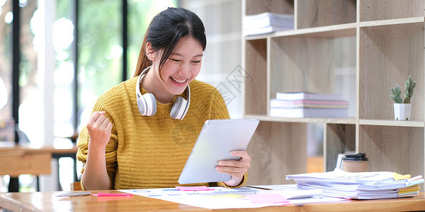 亚洲女学生在线学习班学习在线视频通话 zoom 老师 快乐的亚洲女孩用电脑笔记本电脑在线学习英语家庭作业学生青少年教育女士办公室背景