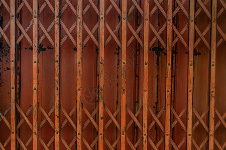 古老的橙色铁门对背景 钢铁折叠门 泰国来说非常生锈纹理建筑建筑学艺术街道房屋背景