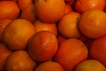 市场上的普通柑橘收成果汁水果橙色背景图片
