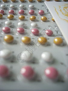 避孕药丸胶囊黄色红色荷尔蒙白色药物处方女士药片口服背景图片