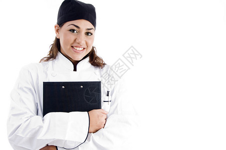 拥有笔记板的美丽女厨师工作工作室青年美食黑发厨房衣服冒充成人职员背景图片