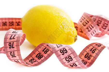 石灰和胶带测量黄色水果仪表磁带白色食物柠檬背景图片