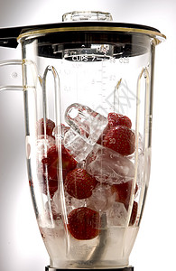 印度半透明草莓草莓和冰在混合器立方体赞成塑料香气背景