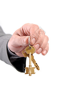男地产经理手持两把钥匙商业礼物人士力量金属财产市场安全办公室金融背景图片