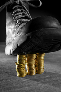 用靴子踏着三枚硬币的柱子背景图片