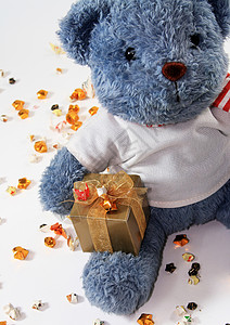 手拿礼物熊恒星纸背景的泰迪熊背景