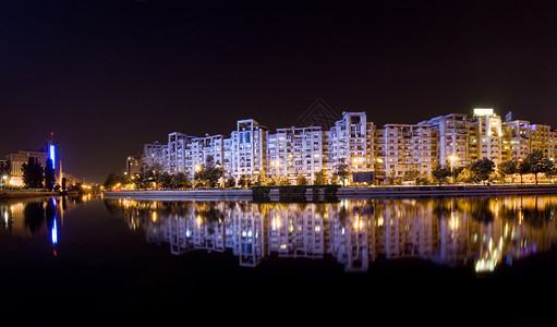 布加勒斯特夜间日落议会首都全景市政反射树木天空汽车建筑背景图片