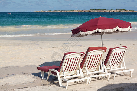 红色的伞3个沙滩休闲游客和沙上雨伞塑料热带旅行天堂假期靠垫座位三重奏太阳明信片背景