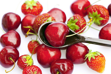 樱桃和草莓在一勺小勺中 孤立于白色水果生活勺子叶子工作室宏观餐具活力厨房剪裁背景图片