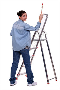 女性DIY粉丝用油漆刷和梯子站立高清图片