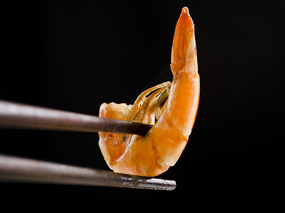 筷子上的虾黑色的爆虾高清图片