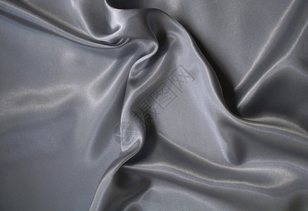 平滑优雅的银色灰色丝绸作为背景衣服投标折痕金属海浪寝具布料生产涟漪纺织品背景图片