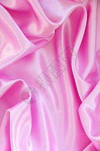 平滑优雅的粉色丝绸作为背景投标织物海浪材料布料纺织品曲线婚礼薰衣草背景图片
