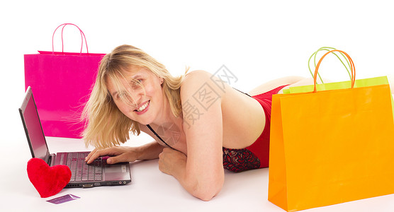 有吸引力的妇女在互联网上购物 女性在网上购物客户互联网购物狂网店电脑大学工作室销售地面学生背景图片