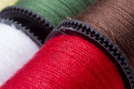 红色中国风扇形卷轴线索的宏工具织物宏观纺织品红色生产卷轴拼接工艺棉布背景