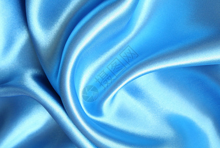 平滑优雅的蓝色丝绸作为背景曲线折痕材料奢华感性礼物织物银色纺织品版税背景图片