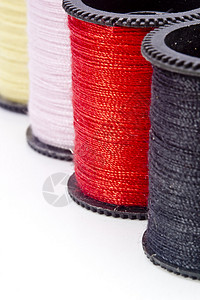 红色贴线素材线索的宏织物纺织品生产工艺卷轴刺绣衣服拼接缝纫材料背景