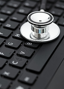 键盘上的立體镜医疗电脑医生桌子诊断技术电子笔记本金属背景图片