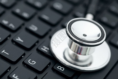 键盘上的立體镜诊断电脑笔记本桌子技术金属医生黑色医疗电子背景图片