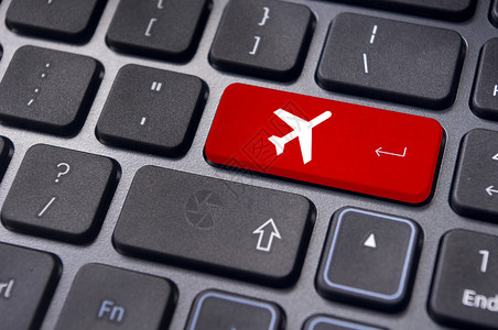 在线订机票 键盘上标有飞机标志飞行电脑网站交通工具互联网按钮运输空气登机客票背景