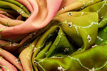 绿色布料粉色和绿色面料纺织品奢华艺术天鹅绒金子坡度衣服珍珠版税织物布料背景