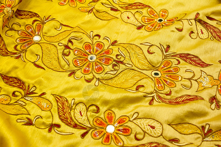 飘忽不定的黄沙丁色纺织品金子衣服艺术曲线奢华版税涟漪织物天鹅绒亚麻背景