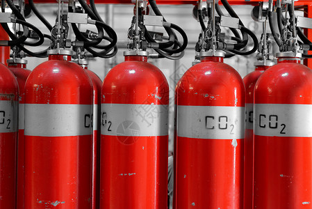 红色灭火器发电厂大型CO2灭火灭火器建筑管道红色工具情况保险圆柱安全植物二氧化碳背景