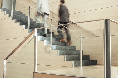 商务人士在办公室上楼时行动模糊的动作楼梯管理人员正装成人商业职场职业人士运动脚步背景图片